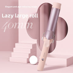 A 40mm curling iron with a metallic rose gold barrel and a pastel pink handle, displayed on a pink geometric studio background with text overlays.