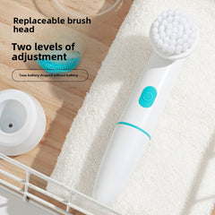 White and blue electric brush with replaceable brush head on a wooden surface with towel.
