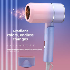 A pastel gradient hair dryer shown on a pink-to-blue background with promotional text. The dryer has a soft pink-to-lavender gradient body with a metallic silver ring and a matching lavender concentrator attachment below it.